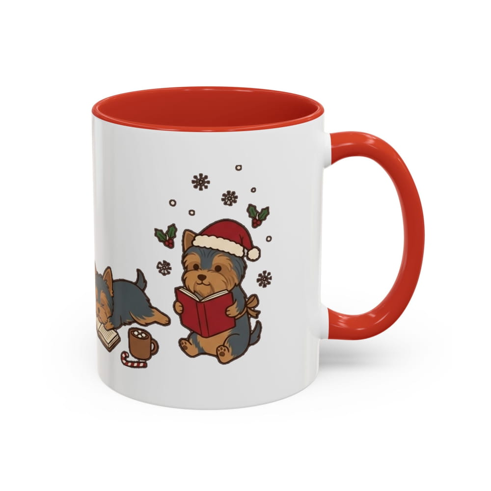 White ceramic mug with a red interior and red handle, showing a Yorkie in a Santa hat reading a red book, with another Yorkie lying beside it.