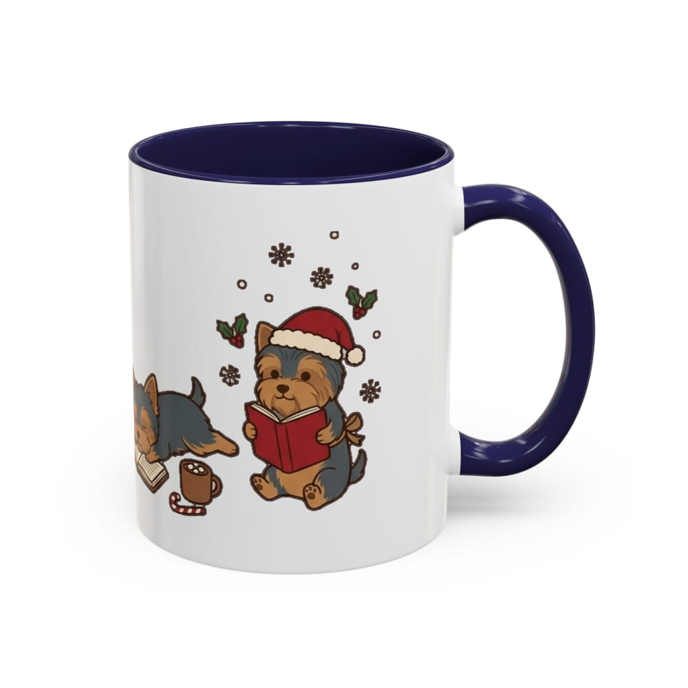 White ceramic mug with a navy interior and navy handle, showing a Yorkie in a Santa hat reading a red book, with another Yorkie lying beside it.