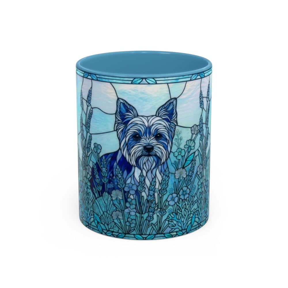 A ceramic mug featuring a blue and white stained-glass style illustration of a small terrier dog surrounded by flowers, shown on a plain white background.